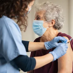 An elderly person receiving injection