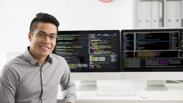 A man sitting in front of computer screen